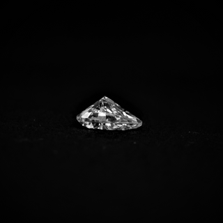 Back view of pear cut moissanite—deep facets and sharp edges reflect light with a bold and bright sparkle.